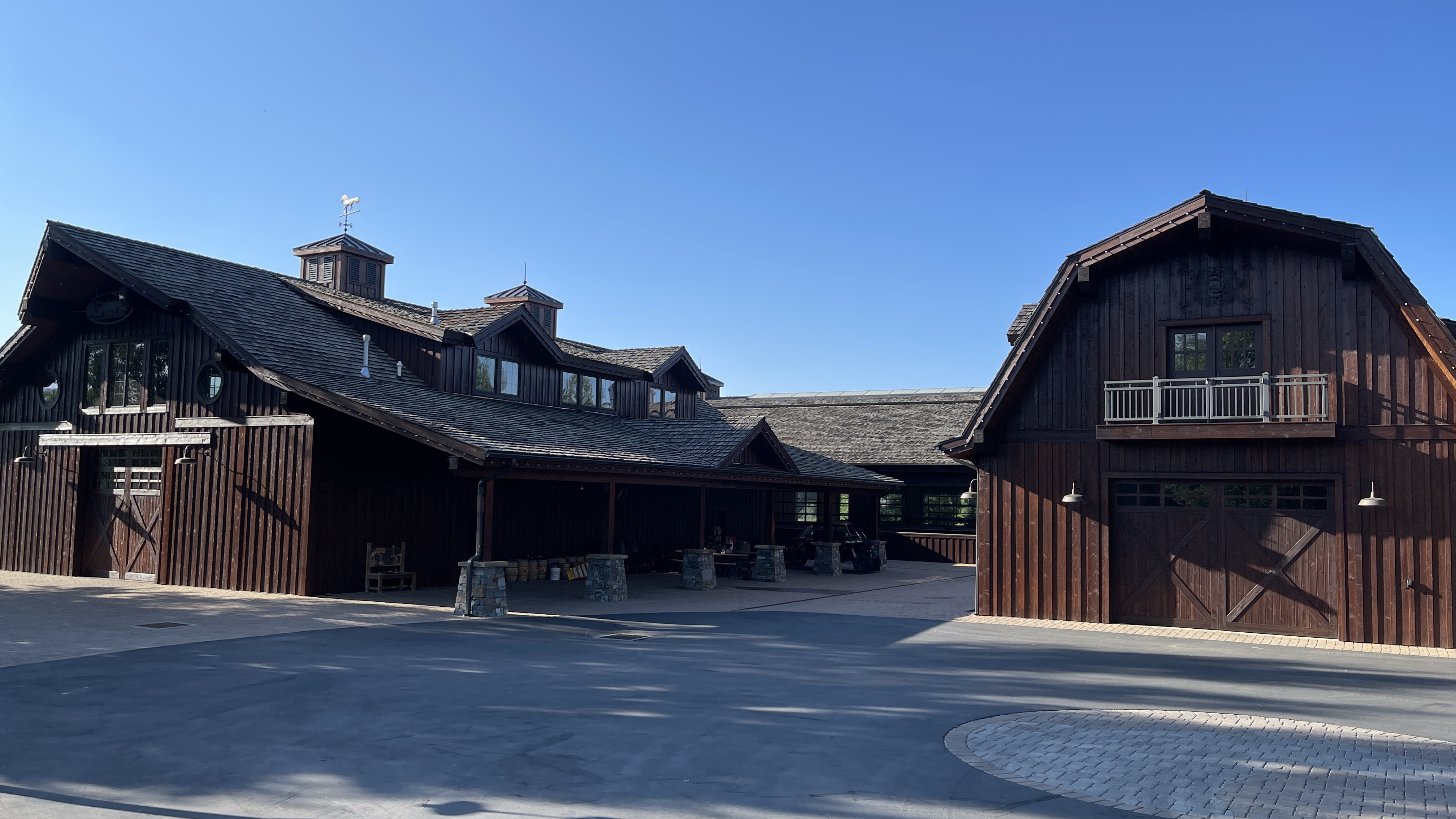 Dark-stained barn and outbuilding complex with courtyard — Summit County, Utah