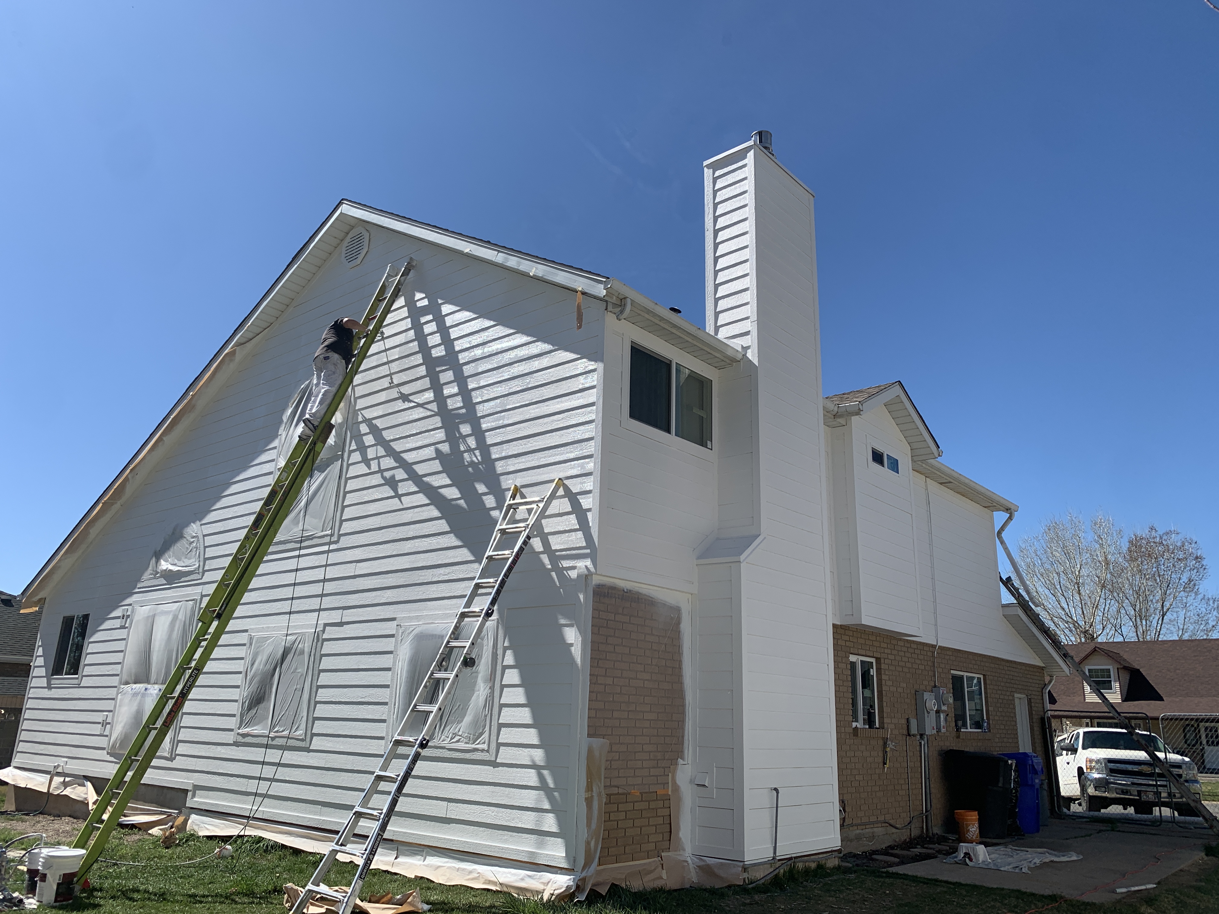 The Stain Bros crew painting a home exterior in Summit County, Utah