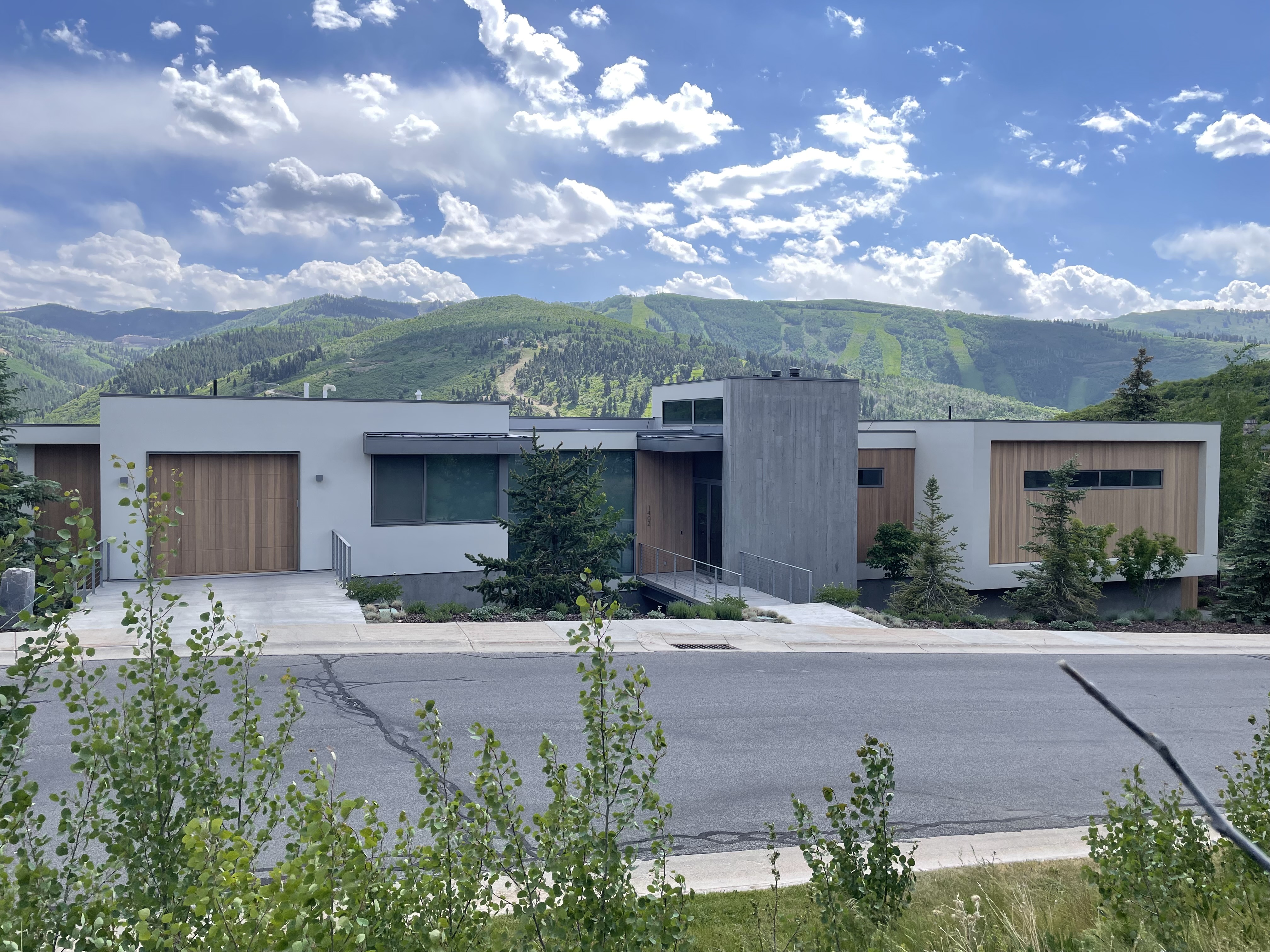 Modern flat-roof home with Deer Valley ski mountain behind it — Park City, Utah