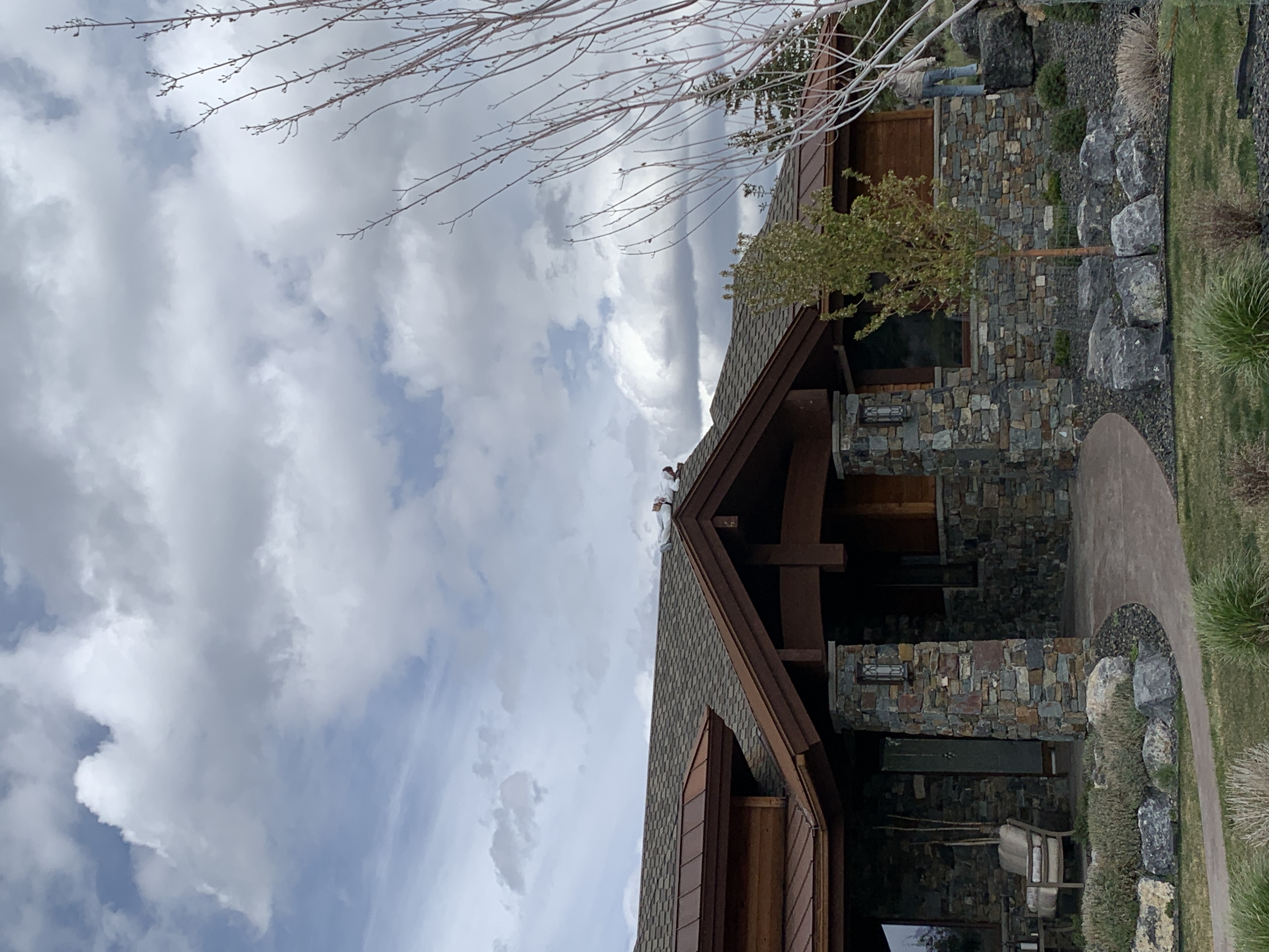 Luxury stone and cedar home with copper trim and dramatic sky — Summit County, Utah